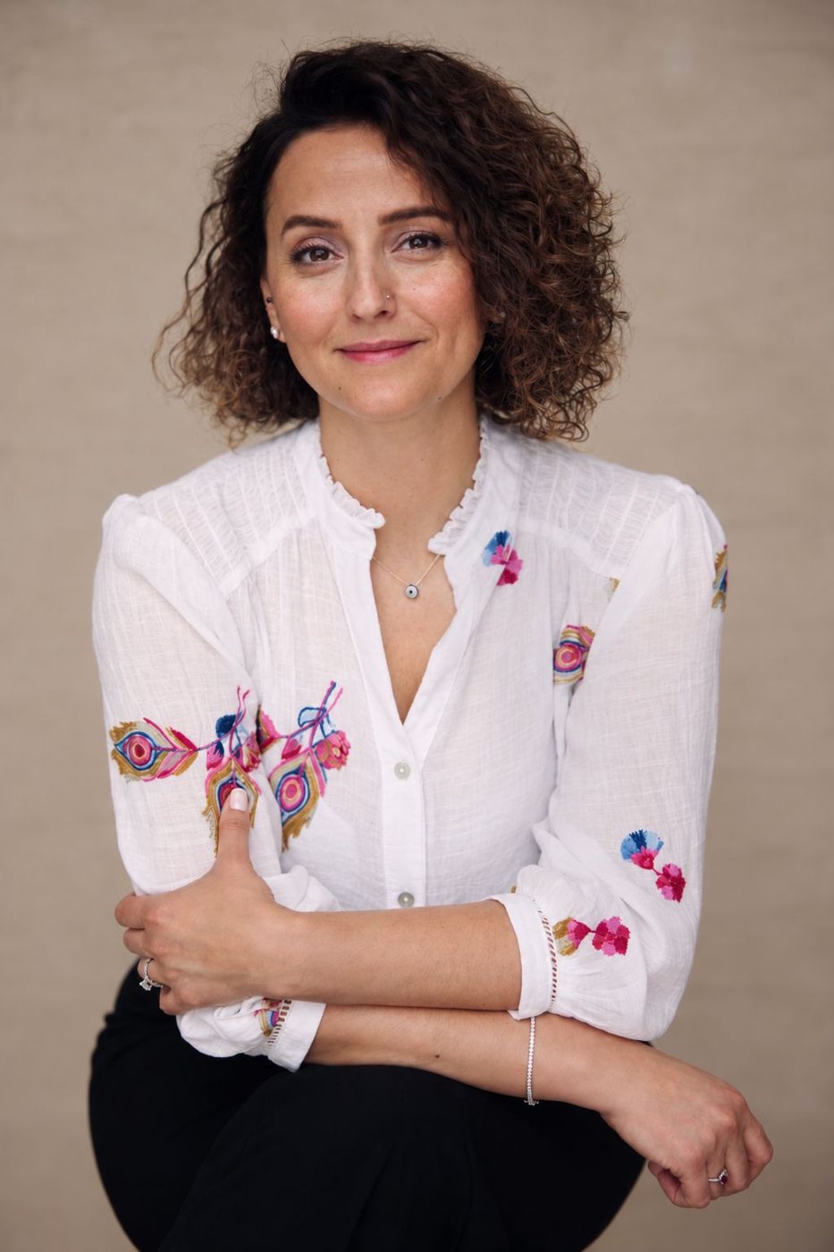 Portrait of Tuba Bircan in an embroidered white blouse